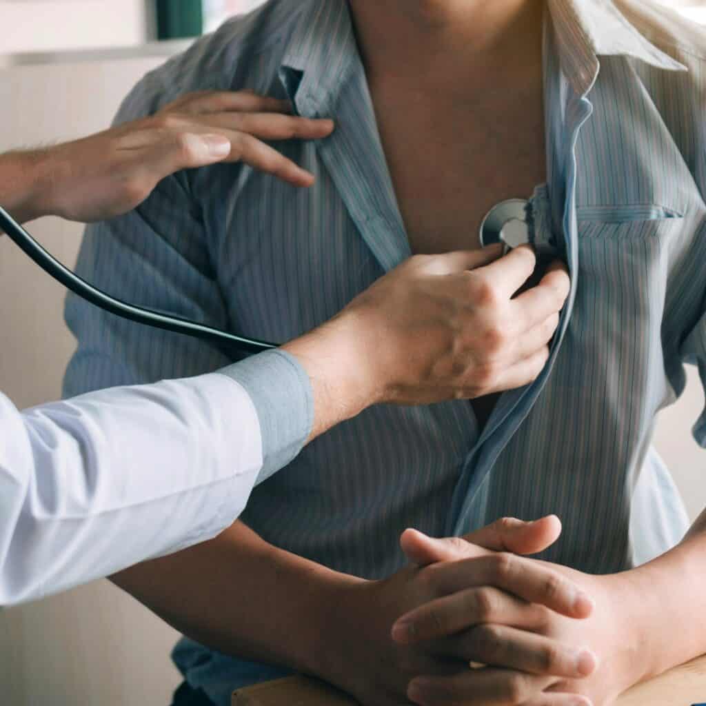 A medical provider checking a patient with a stethoscope.